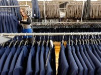 Sandra Brito matches the tops with the corresponding pants before the complete suit is shipped out at the Joseph Abboud manufacturing plant in New Bedford, MA.   [ PETER PEREIRA/THE STANDARD-TIMES/SCMG ]